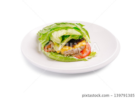 Lettuce wrap burger with cheese and tomato on a white plate Lettuce wrap burger with cheese and tomato on a white plate 139791385