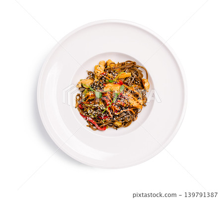 Noodles with vegetables and shrimp served in a round white bowl on a table Noodles with vegetables and shrimp served in a round white bowl on a table 139791387