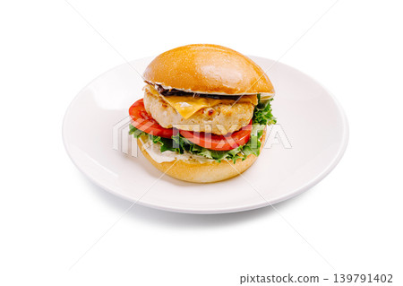 Chicken burger on a plate with fresh vegetables and a bun 139791402
