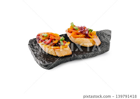 Delicious bread slices topped with colorful vegetables on a dark stone plate Delicious bread slices topped with colorful vegetables on a dark stone plate 139791418