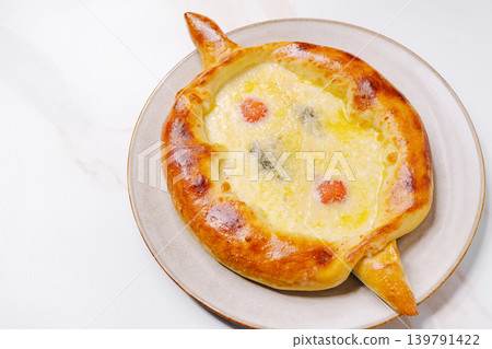 Freshly baked khachapuri from Georgia served on a plate with cheese Freshly baked khachapuri from Georgia served on a plate with cheese 139791422