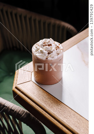 Coffee drink on a table in a cozy setting with simple design elements Coffee drink on a table in a cozy setting with simple design elements 139791429
