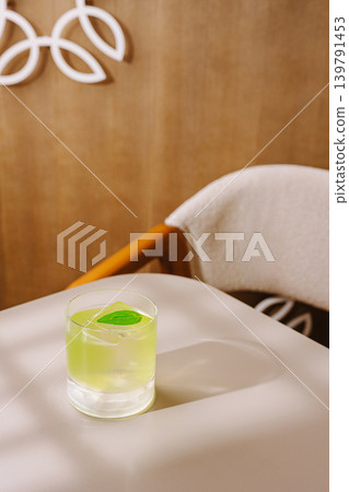 Mixing a fresh drink on a table in a cozy indoor setting during the afternoon Mixing a fresh drink on a table in a cozy indoor setting during the afternoon 139791453