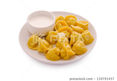 Dumplings served with sauce on a plate during dinner time Dumplings served with sauce on a plate during dinner time 139791457