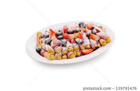 Sweet crepes with berries and powdered sugar on a white plate Sweet crepes with berries and powdered sugar on a white plate 139791476