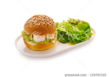 Shrimp sandwich with salad served on a white plate in a well-lit kitchen Shrimp sandwich with salad served on a white plate in a well-lit kitchen 139791505