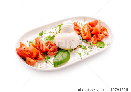 Fresh burrata and tomato salad served on a white plate Fresh burrata and tomato salad served on a white plate 139791506