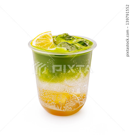 Fresh drink with layers of color served in a clear cup with lime on top Fresh drink with layers of color served in a clear cup with lime on top 139791552