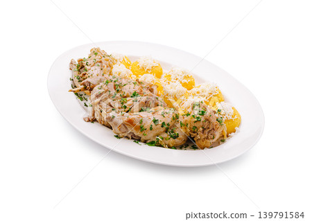 Delicious chicken served with potatoes and cheese on a white plate Delicious chicken served with potatoes and cheese on a white plate 139791584