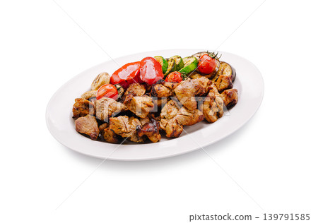 Grilled meat and vegetables served on a white plate in a simple setting Grilled meat and vegetables served on a white plate in a simple setting 139791585