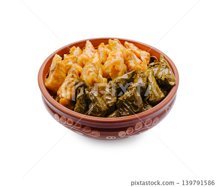 Plates of stuffed cabbage and grape leaves served in a bowl Plates of stuffed cabbage and grape leaves served in a bowl 139791586