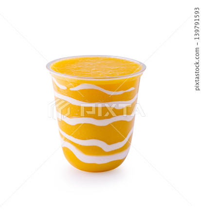 Fresh mango smoothie served in a striped cup at a summer event Fresh mango smoothie served in a striped cup at a summer event 139791593