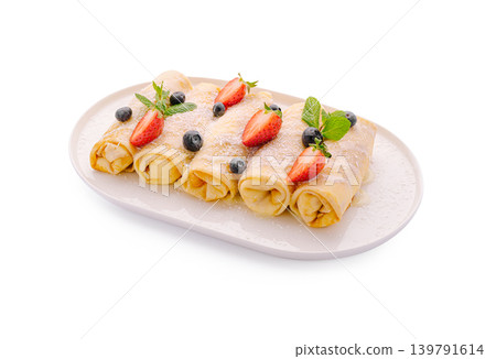 Delicious crepes filled with fruit and topped with berries and mint 139791614