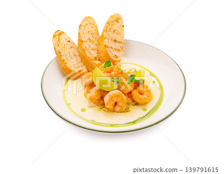 Shrimp dish with lime and toasted bread served on a white plate Shrimp dish with lime and toasted bread served on a white plate 139791615