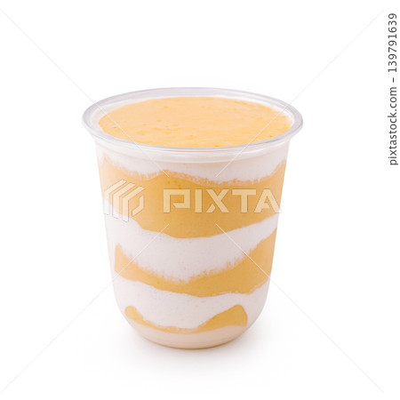 Mango dessert in a clear cup with layers of cream and mango puree Mango dessert in a clear cup with layers of cream and mango puree 139791639