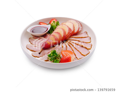 Delicious platter of sliced meat and fruit served in a round dish 139791659