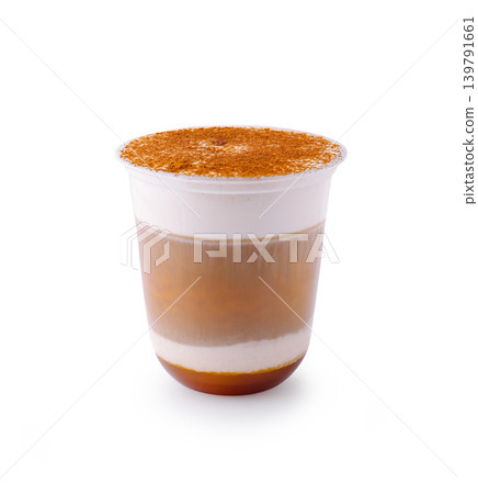 Delicious layered drink in clear cup showing coffee and cream Delicious layered drink in clear cup showing coffee and cream 139791661