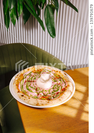 Fresh pizza with toppings on a wooden table in a cozy restaurant setting Fresh pizza with toppings on a wooden table in a cozy restaurant setting 139791679