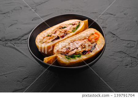 Delicious sandwich served in a black bowl with fresh ingredients and meat Delicious sandwich served in a black bowl with fresh ingredients and meat 139791704