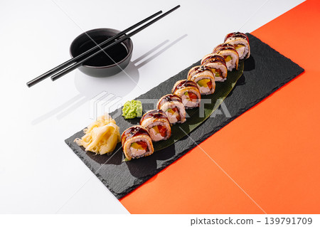 Sushi served on a black plate with chopsticks and side condiments Sushi served on a black plate with chopsticks and side condiments 139791709
