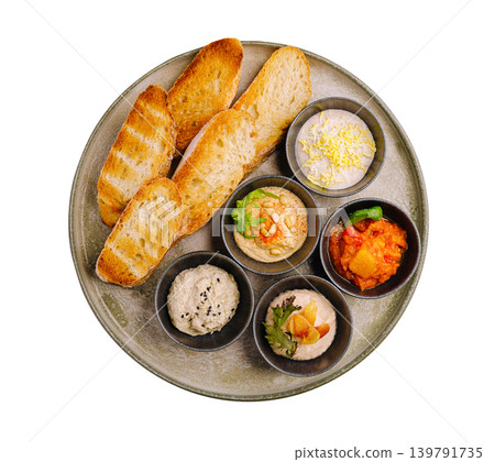 Different dips and toasted bread served in a round platter at a restaurant 139791735