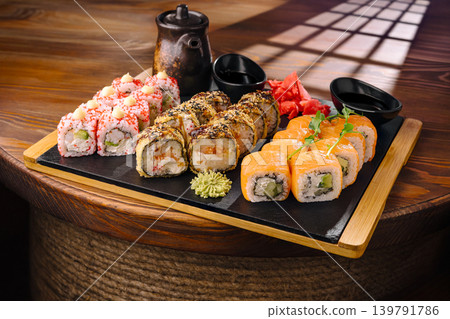 Fresh sushi served on a wooden platter with pickled ginger and wasabi Fresh sushi served on a wooden platter with pickled ginger and wasabi 139791786
