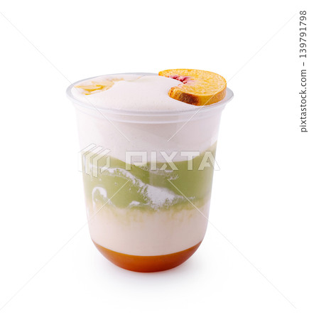 Colorful dessert layers topped with fruit slice in a clear cup Colorful dessert layers topped with fruit slice in a clear cup 139791798