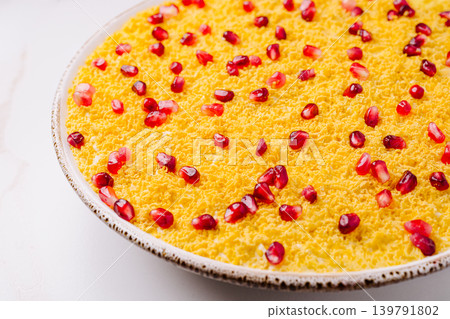 Saffron dessert topped with pomegranate seeds on a plate Saffron dessert topped with pomegranate seeds on a plate 139791802