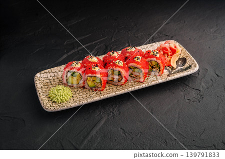 Sushi rolls served on a plate with wasabi and ginger at a restaurant Sushi rolls served on a plate with wasabi and ginger at a restaurant 139791833