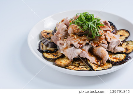 Grilled eggplant topped with thinly sliced pork (white background) Grilled eggplant topped with thinly sliced pork (white background) 139791845