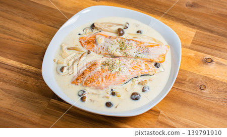 Salmon and mushroom cream stew placed on a wooden table Salmon and mushroom cream stew placed on a wooden table 139791910