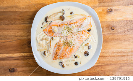 Salmon and mushroom cream stew placed on a wooden table Salmon and mushroom cream stew placed on a wooden table 139791915