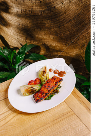 Fresh grilled salmon with vegetables served on a white plate Fresh grilled salmon with vegetables served on a white plate 139792265
