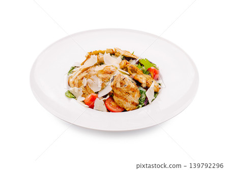 Grilled chicken salad with vegetables on white plate at restaurant 139792296