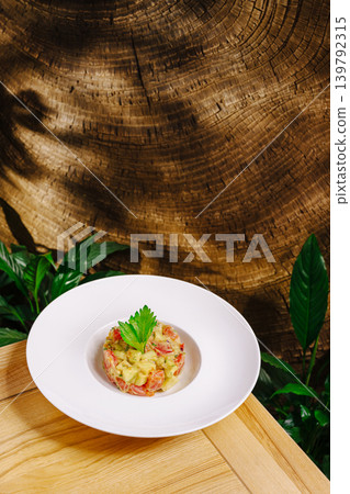 Gourmet salmon tartare with avocado on wooden background Gourmet salmon tartare with avocado on wooden background 139792315