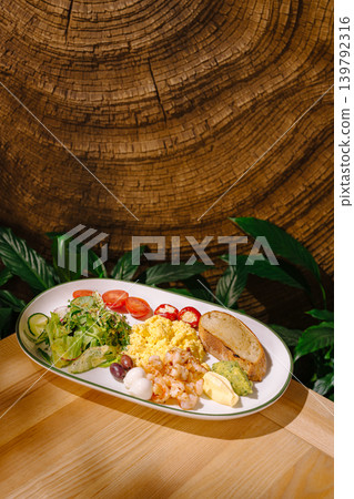 Fresh seafood dish served on white plate with vegetables on wooden table Fresh seafood dish served on white plate with vegetables on wooden table 139792316