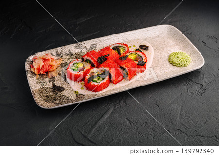 California sushi rolls with red tobiko and sauce on a white plate California sushi rolls with red tobiko and sauce on a white plate 139792340