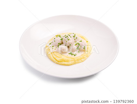 A serving of mashed potatoes is placed in a round bowl A serving of mashed potatoes is placed in a round bowl 139792360