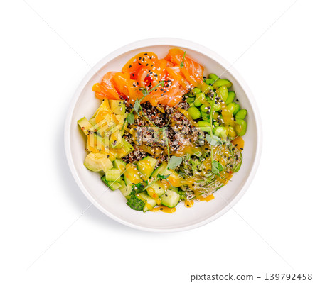 Healthy bowl with salmon, avocado, edamame, and quinoa served in a white dish 139792458