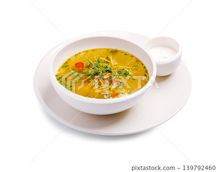Warm soup with herbs and spices served with a side of cream Warm soup with herbs and spices served with a side of cream 139792460