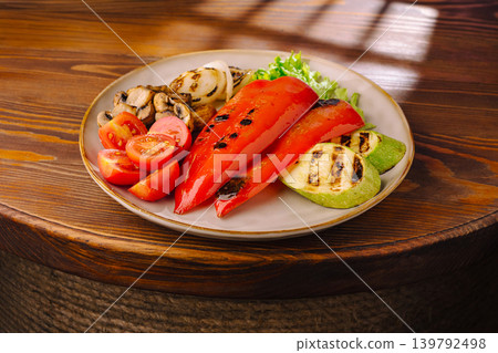 Grilled peppers and vegetables served on a plate at a restaurant Grilled peppers and vegetables served on a plate at a restaurant 139792498