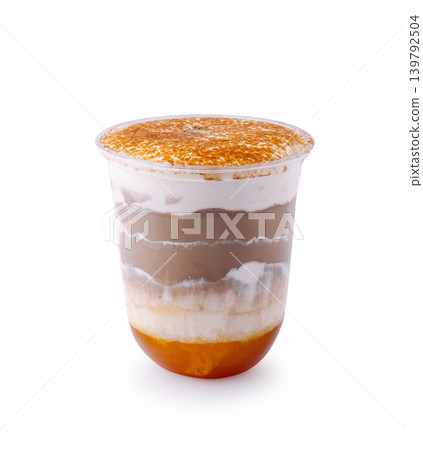 Layered dessert in clear cup with caramel and cream top at dessert shop 139792504