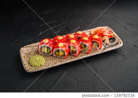 Sushi rolls with red topping served on a plate with wasabi and ginger Sushi rolls with red topping served on a plate with wasabi and ginger 139792516