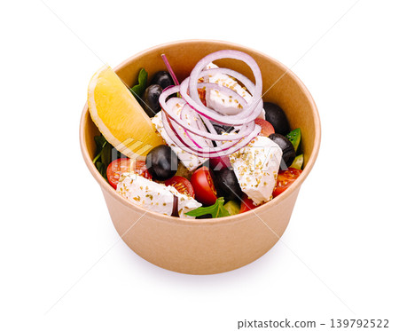 Fresh salad with vegetables, cheese, and lemon slice served in a bowl Fresh salad with vegetables, cheese, and lemon slice served in a bowl 139792522