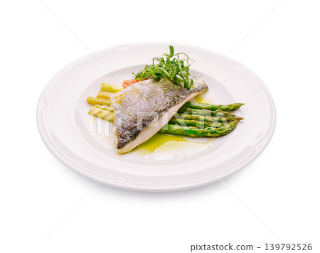Grilled fish with asparagus and garnish on a plain white plate Grilled fish with asparagus and garnish on a plain white plate 139792526