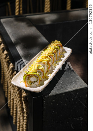 Sushi rolls arranged on a plate in a restaurant setting during daytime Sushi rolls arranged on a plate in a restaurant setting during daytime 139792536