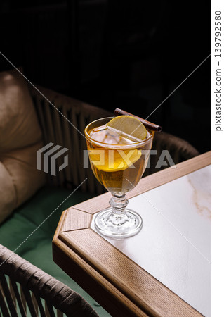 Refreshing drink served on a table with a cozy seating area at night Refreshing drink served on a table with a cozy seating area at night 139792580