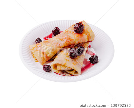 Delicious crepes served on a white paper plate with cherry topping Delicious crepes served on a white paper plate with cherry topping 139792583