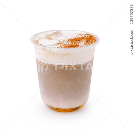 Iced coffee drink with foam and cinnamon on top in clear cup Iced coffee drink with foam and cinnamon on top in clear cup 139792588