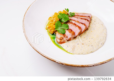 Duck breast served with sauce and corn salsa on a white plate Duck breast served with sauce and corn salsa on a white plate 139792634